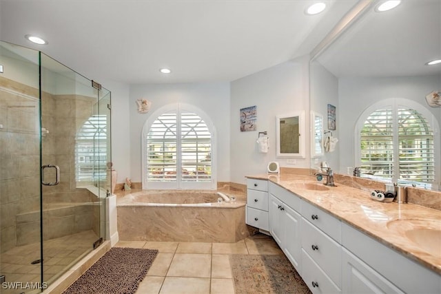 bathroom with tile patterned flooring, vanity, a wealth of natural light, and independent shower and bath