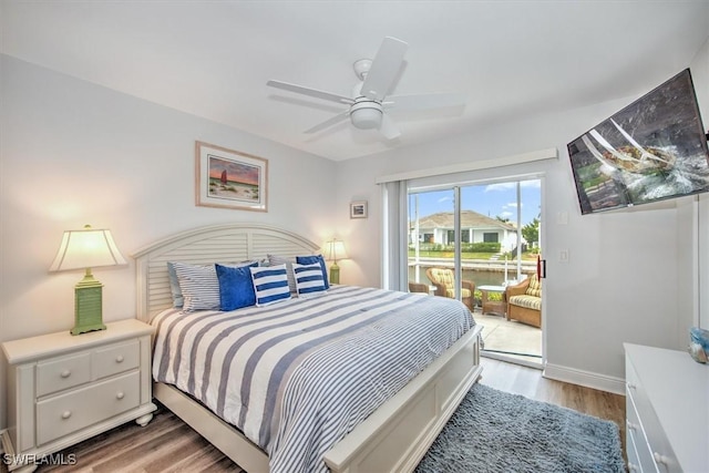 bedroom with hardwood / wood-style flooring, access to outside, and ceiling fan