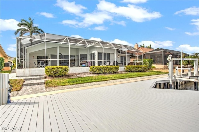 rear view of property featuring glass enclosure