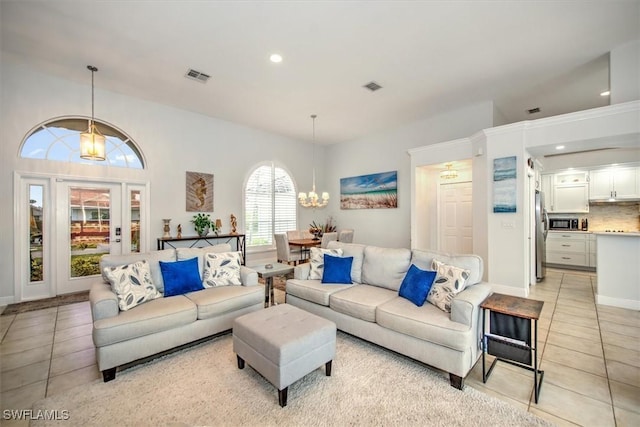 living room featuring an inviting chandelier and light tile patterned floors