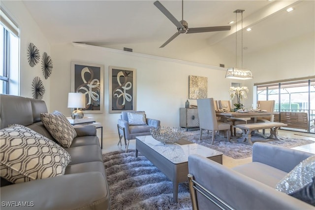 living room with beamed ceiling, ceiling fan, and high vaulted ceiling