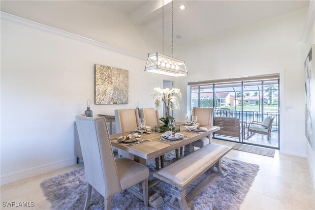 dining room with beamed ceiling, a towering ceiling, and light tile patterned floors