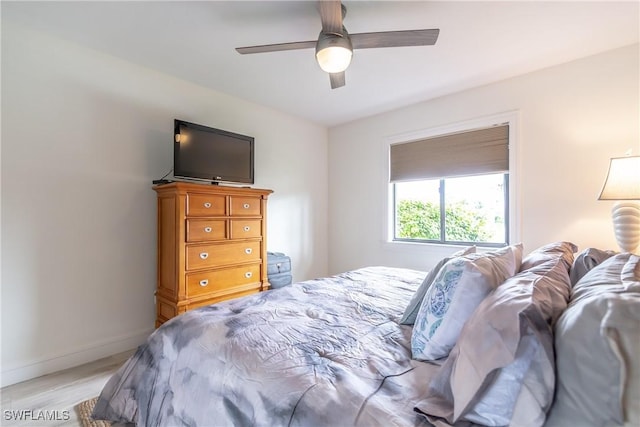 bedroom with ceiling fan and light hardwood / wood-style flooring