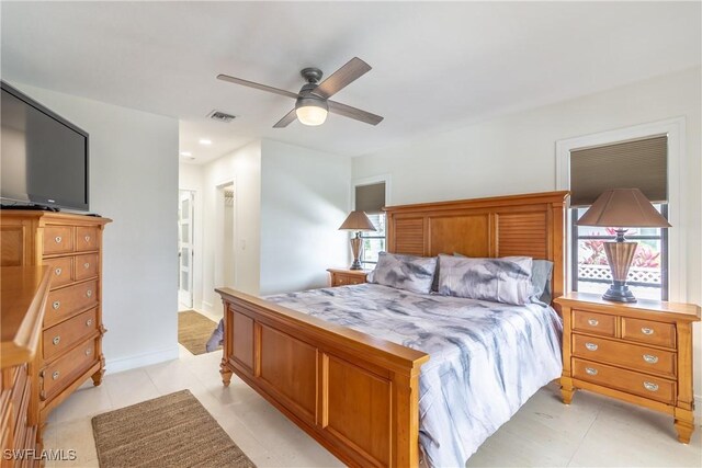 tiled bedroom with ceiling fan