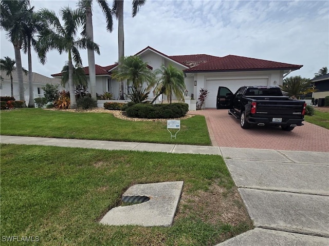 view of front of house with a garage and a front yard