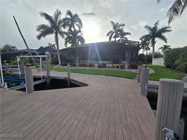 dock area featuring a yard and glass enclosure