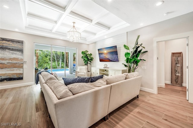 living room featuring beamed ceiling, coffered ceiling, light hardwood / wood-style flooring, and a chandelier