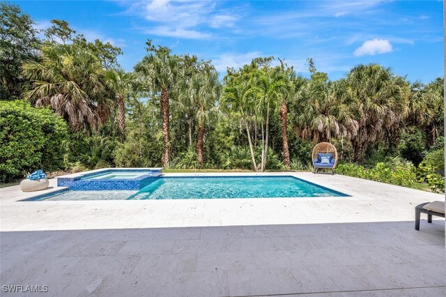 view of pool featuring an in ground hot tub and a patio