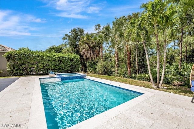 view of pool featuring a patio area and a pool with connected hot tub