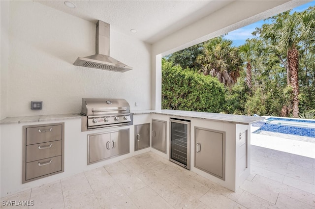 view of patio / terrace with an outdoor pool, an outdoor kitchen, wine cooler, and grilling area