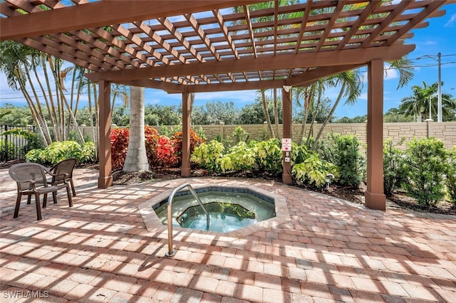 view of swimming pool with an in ground hot tub, a patio, a fenced backyard, and a pergola