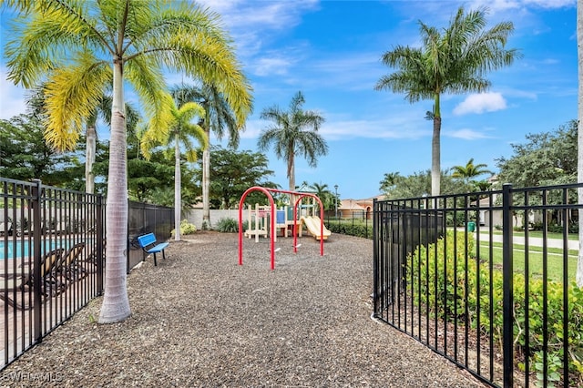 view of playground with a community pool