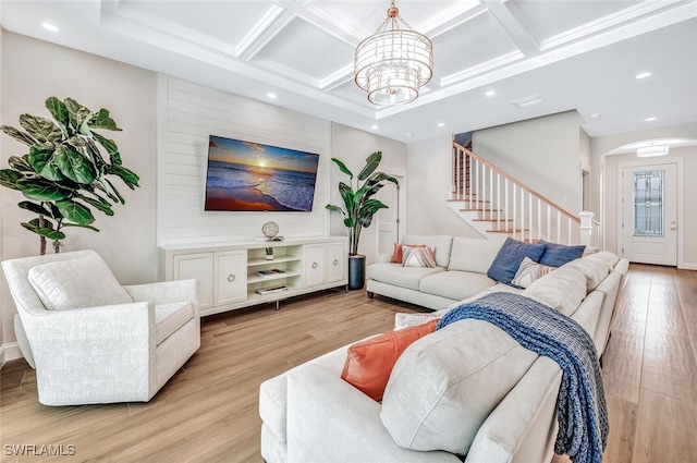 living room featuring arched walkways, recessed lighting, a notable chandelier, coffered ceiling, and light wood-style floors