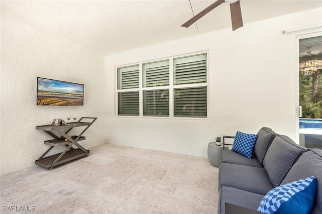 interior space featuring a textured ceiling and ceiling fan