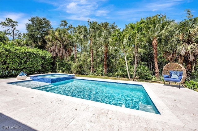 view of pool with a pool with connected hot tub and a patio