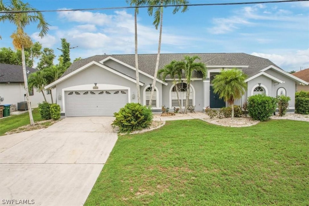 ranch-style house featuring central AC unit, a garage, and a front yard