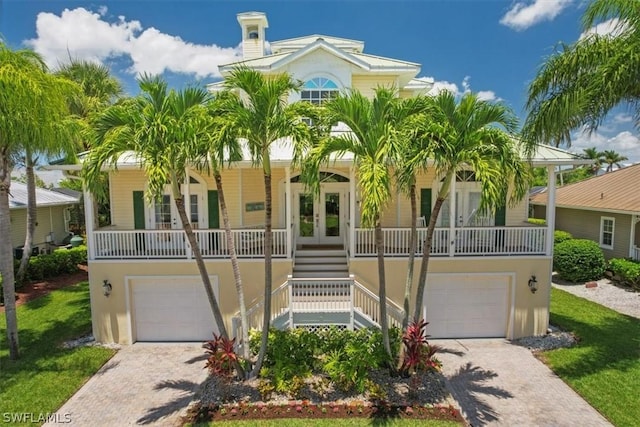 view of front of house featuring a porch and french doors