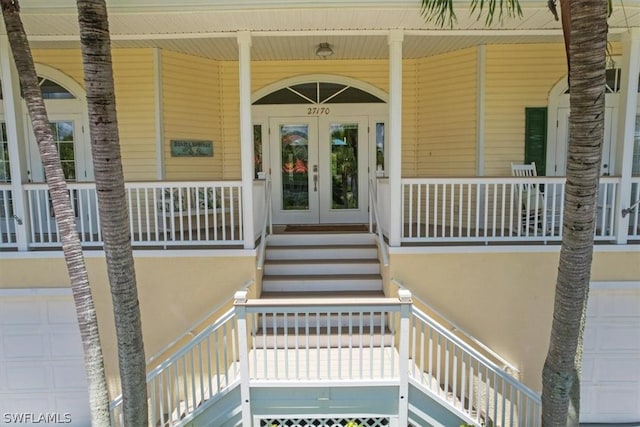 entrance to property with covered porch and french doors