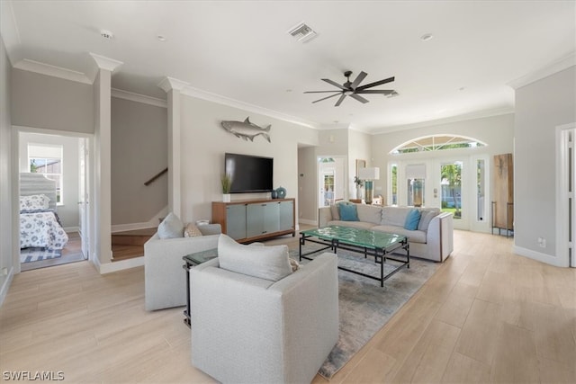 living room with ceiling fan and ornamental molding