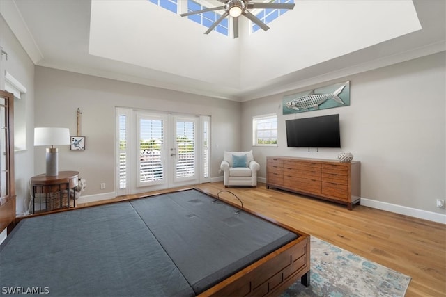 interior space with hardwood / wood-style flooring, crown molding, ceiling fan, and french doors