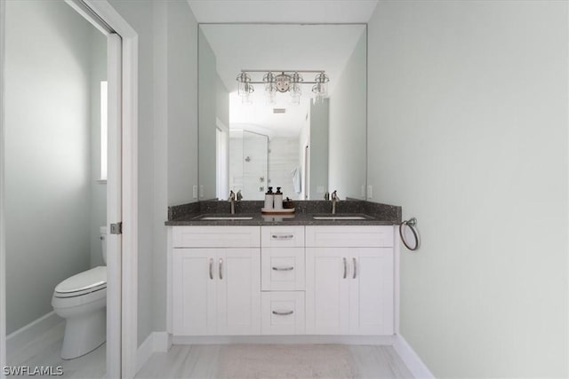 bathroom with tile patterned floors, vanity, and toilet