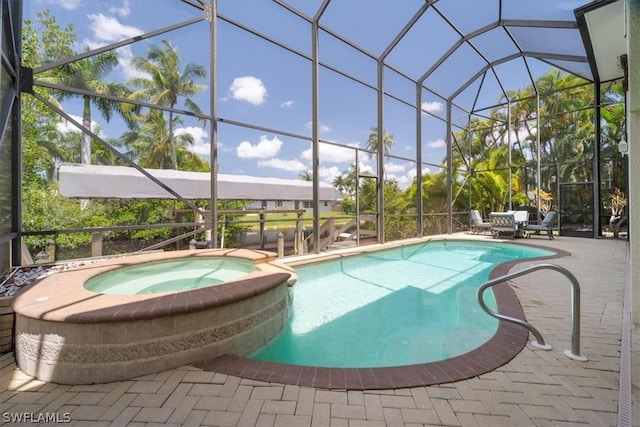 view of swimming pool with a patio, glass enclosure, and an in ground hot tub