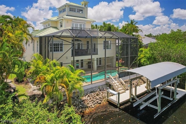 back of property with a balcony, a lanai, and a patio