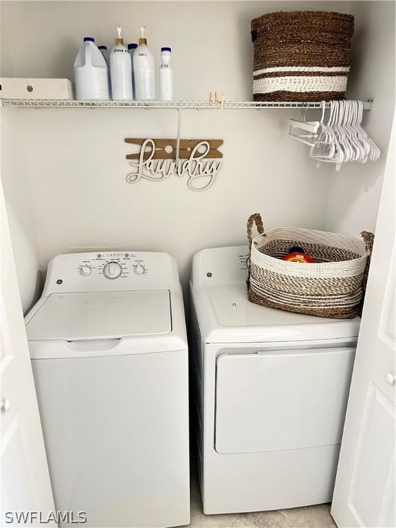 6070 National Blvd Unit 215, Ave Maria, FL 34142 - clothes washing area featuring laundry area and washer and clothes dryer