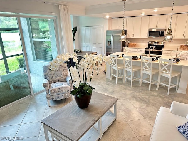 6070 National Blvd Unit 215, Ave Maria, FL 34142 - living area featuring ornamental molding and light tile patterned flooring