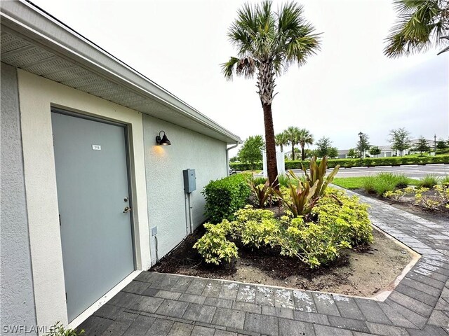 6070 National Blvd Unit 215, Ave Maria, FL 34142 - doorway to property featuring stucco siding