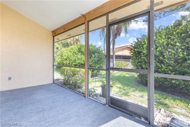 unfurnished sunroom featuring vaulted ceiling