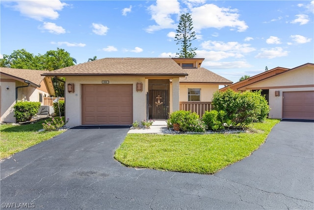 view of front of home featuring a garage and a front lawn