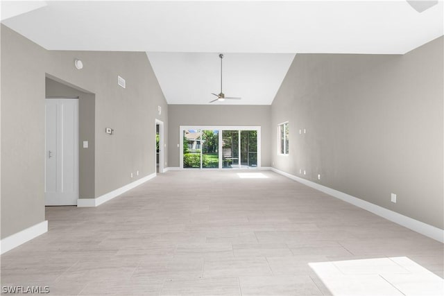 unfurnished living room featuring high vaulted ceiling and ceiling fan