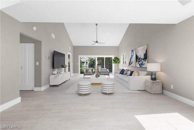 living room featuring ceiling fan and high vaulted ceiling