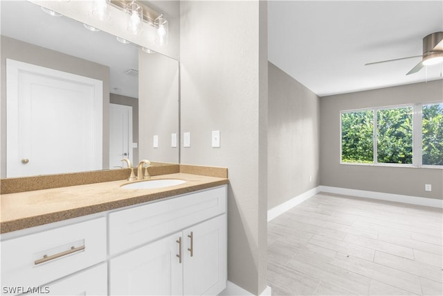 bathroom featuring ceiling fan and vanity