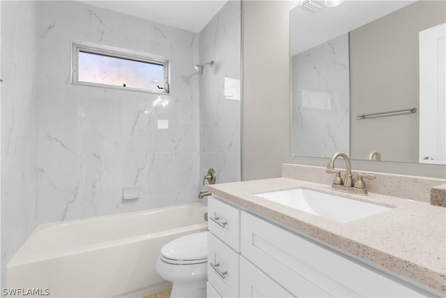 full bathroom featuring toilet, vanity, and tiled shower / bath combo