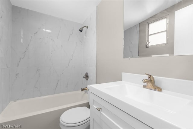 full bathroom featuring tiled shower / bath combo, vanity, and toilet