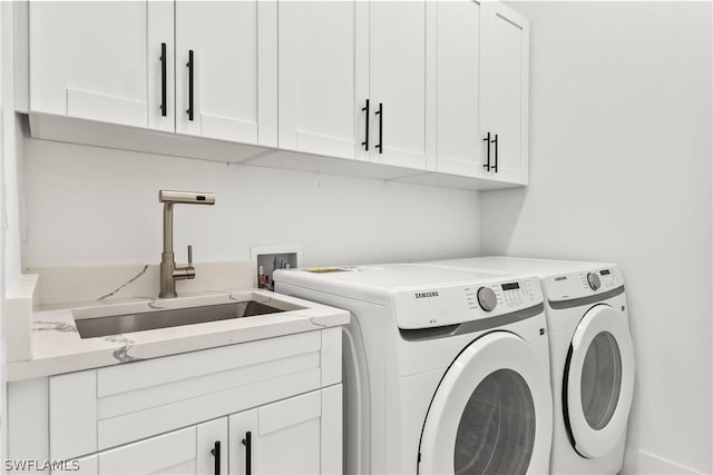 washroom with separate washer and dryer, sink, and cabinets