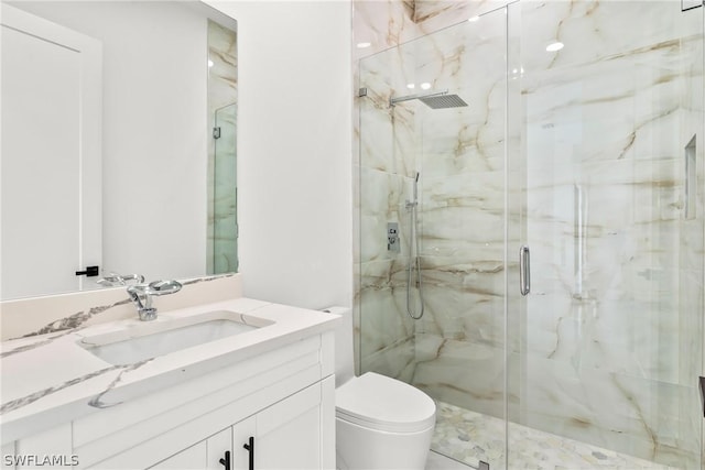 bathroom with walk in shower, vanity, and toilet