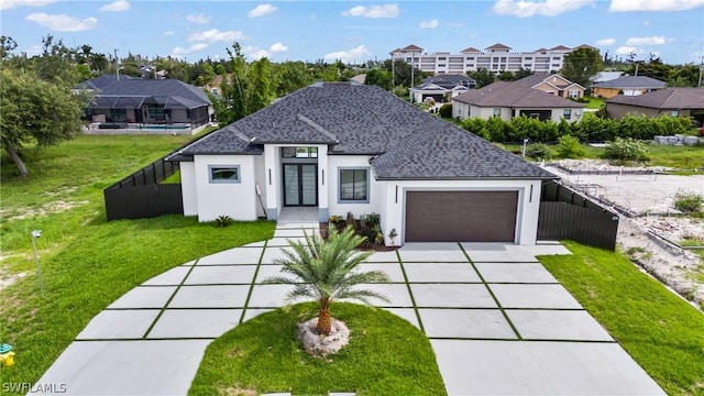 view of front of property with a garage and a front lawn