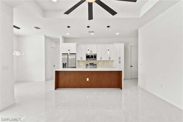 kitchen featuring stainless steel appliances, a large island, sink, and white cabinets