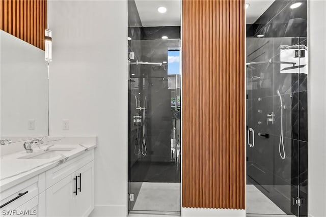 bathroom with vanity and a shower with door