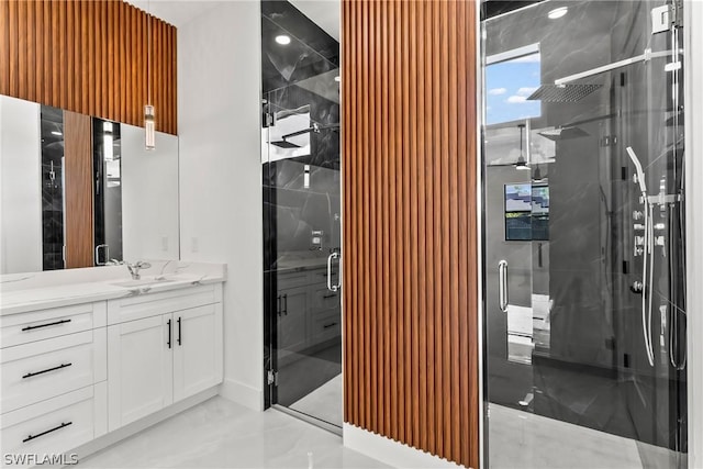 bathroom featuring vanity and a shower with door