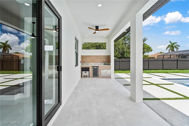 view of patio / terrace featuring area for grilling, a fenced in pool, and ceiling fan