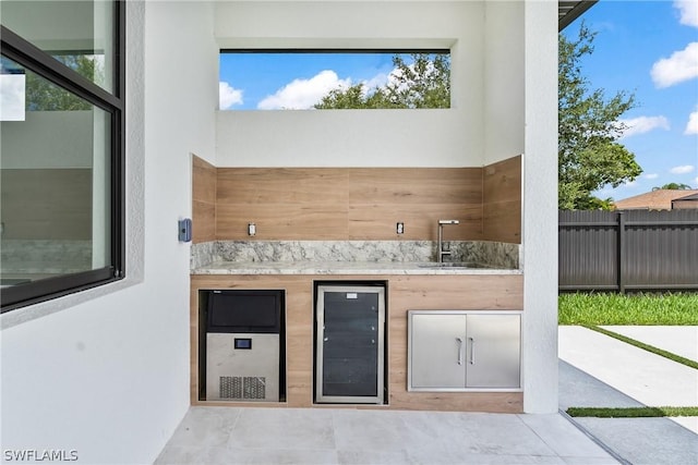 view of patio / terrace with wine cooler, exterior kitchen, and sink