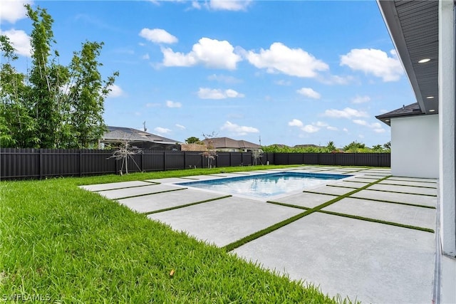 view of swimming pool with a yard and a patio area