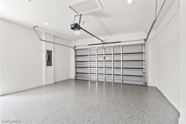 garage with a garage door opener and electric panel