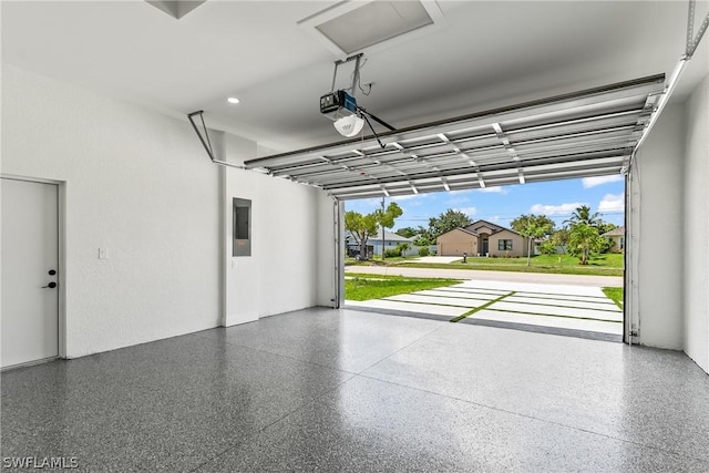 garage with a garage door opener and electric panel