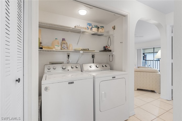 laundry room with separate washer and dryer and light tile patterned floors