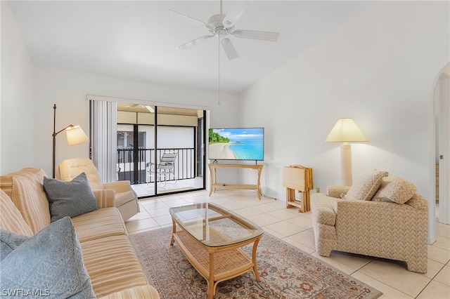 tiled living room with ceiling fan and lofted ceiling